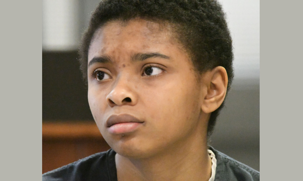 Sex Assault Homicide Defense: Chrystul Kizer headshot - Young black woman with short black hair stares unsmiling with head turned to the left