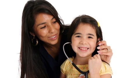 Urban native healthcare national program grant: Native mother putting stethoscope to smiling daughter's ears
