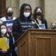 Oxford student seeks gun reform: young black girl with facemask on speaking at podium