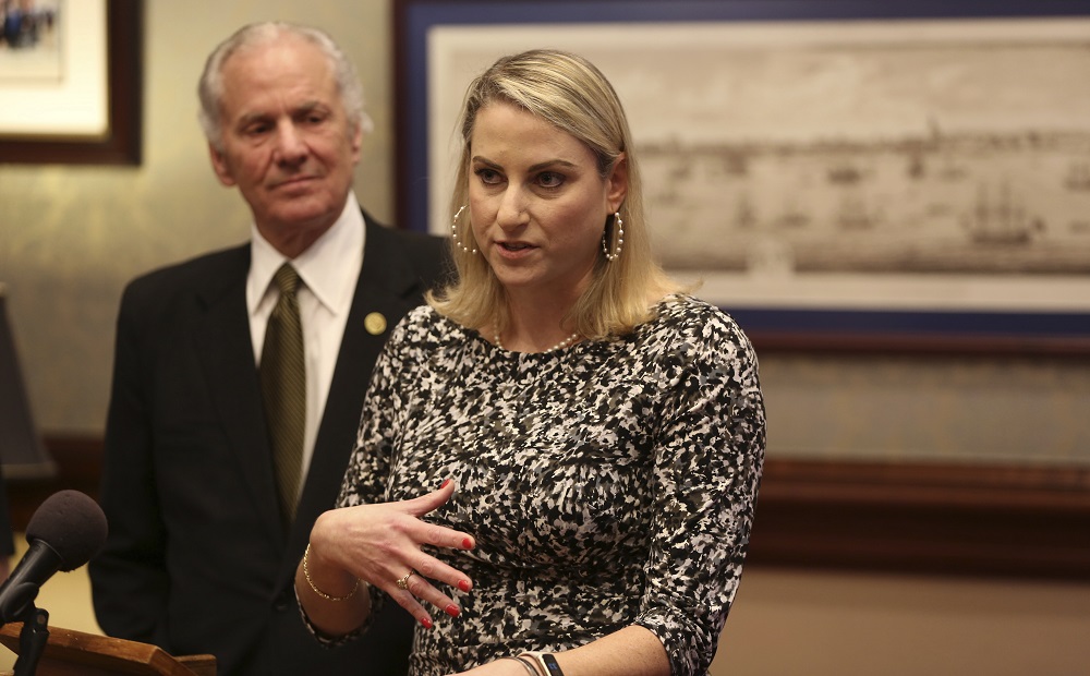 South Carolina gov. names new chief of juvenile justice agency: blonde woman speaking with older white man standing behind