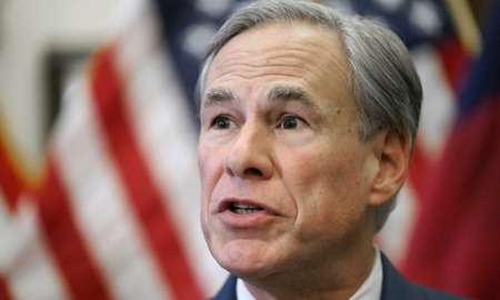 Texas governor order on gender-confirming care: older white man talking in front of American flag background