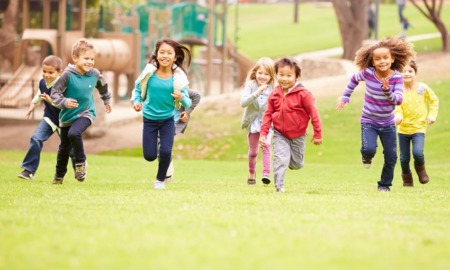 California, Arizona, Nevada child and health grants: group of young children running in park towards camera