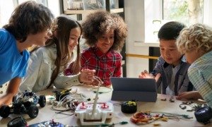 gifted children and disadvantaged student STEM program grants: diverse children work on STEM project at table