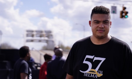 Selma youth voting rights activism: young minority youth looking at camera during march