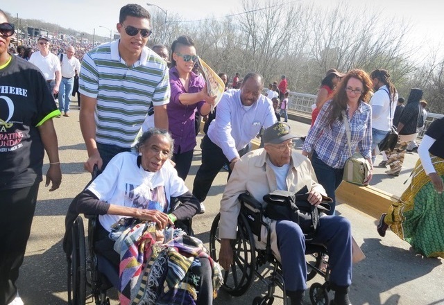 Selma youth voting rights activism: two elderly people being pushed in wheelchairs at march