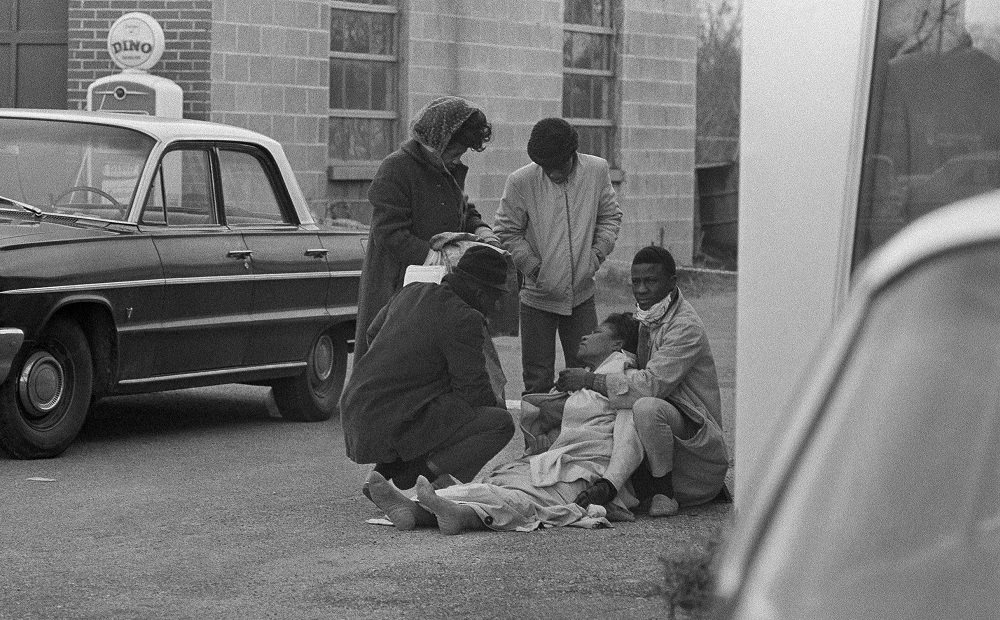 Selma youth voting rights activism: old photo of injured Black woman on ground being helped by others