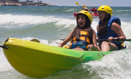 San Diego outdoor spaces grants: two happy young girls in a yellow kayak
