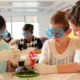 Community health equity and STEM grants: group of young, female students working on science project