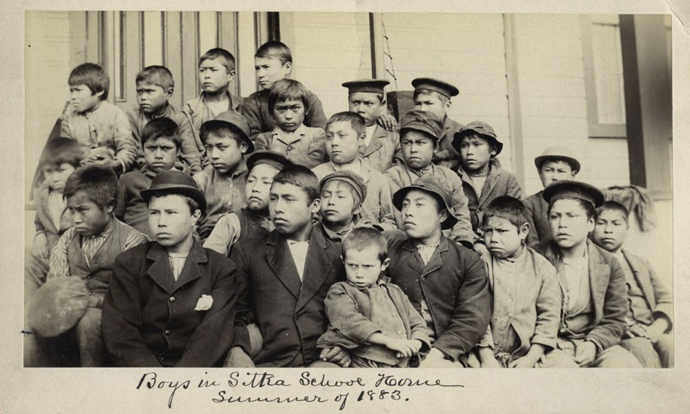 US church boarding school pasts: Old black and white photo of group of children