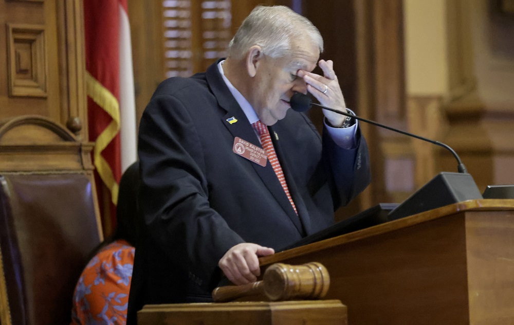 Georgia lawmakers hands transgender decision to sports group: frustrated older white man at podium rubbing forehead