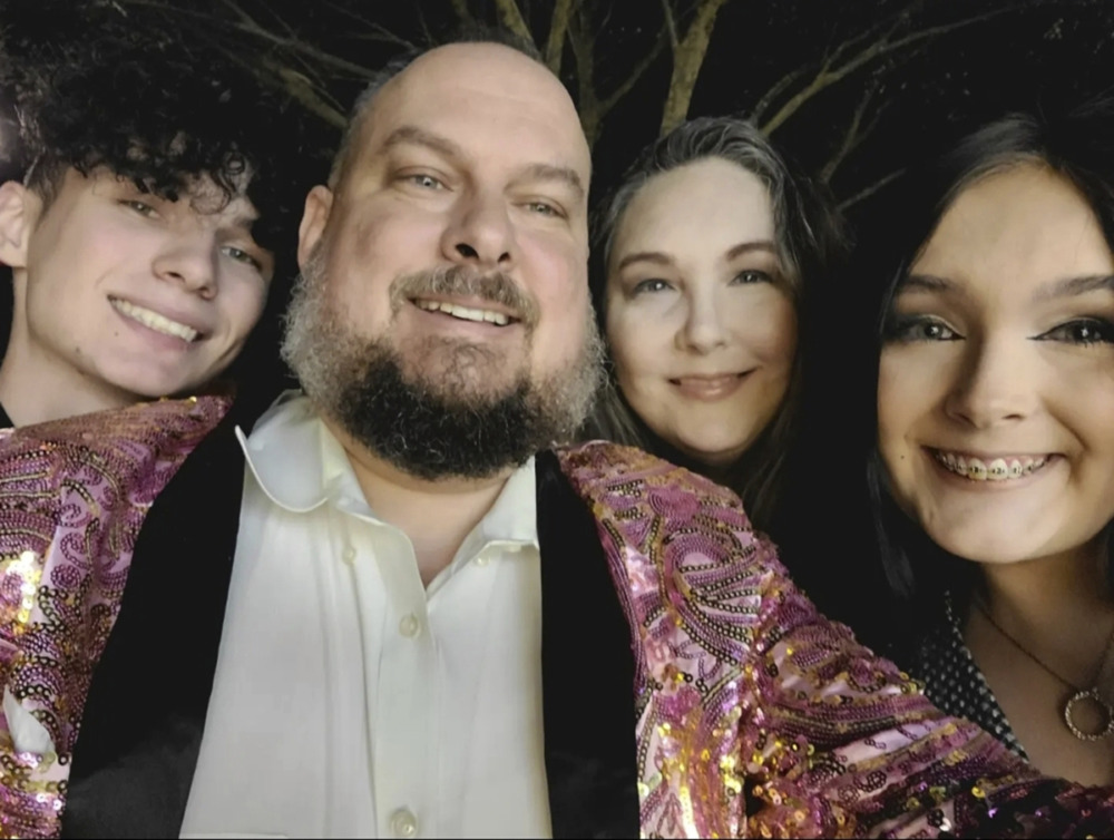 Trans teens Alabama: White family of father other , a teen girl and a teen boy. smile into the camera.