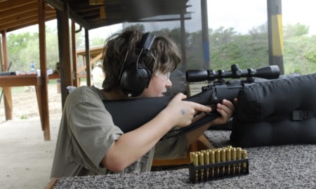 rural youth and guns study: young boy shooting a rifle at shooting range