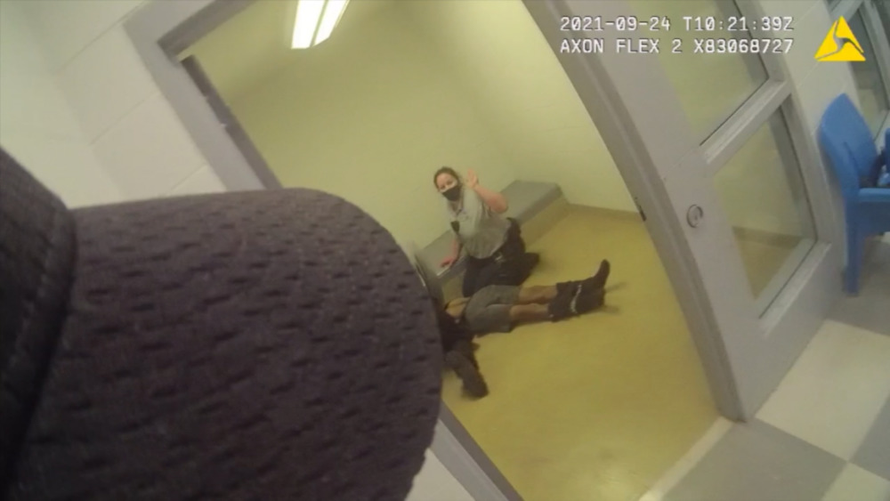 'From crisis to death': Probing teen's last, desperate hours: video still of paramedic on holding cell and lifeless-looking body on floor