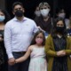 Early transgender identity tends to endure: family stands with facemasks on looking serious
