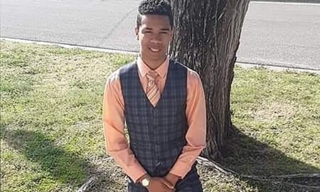 From crisis to death: probing teen's last hours: young black teen in vest and tie posing for picture in front of tree