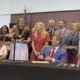 Georgia high school transgender athlete ban: group of people laughing at signing event