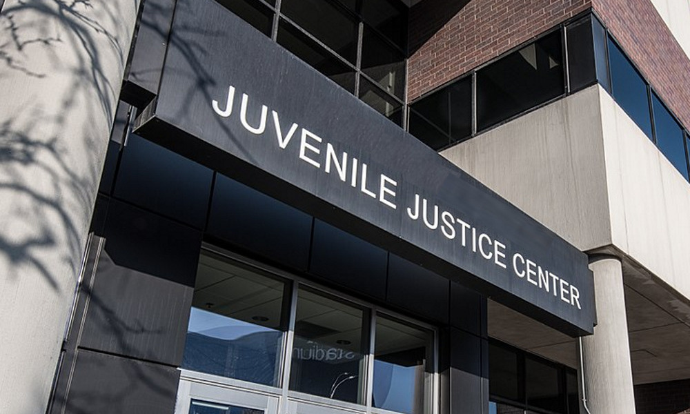 court-involved youth, juvenile justice: Juvenile Juctice Center modern red brick and cement building with black sign