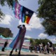 Texas ruling allows trans youth parent investigations: demonstrators gather with trans rights and LGBTQ flags on partly cloudy day