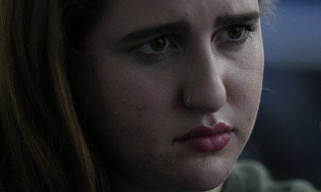 Parkland shooting survivor:: Closeup of teen gitl's face with sad expression