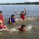 rural afterschool funding problems: group of children in lifevests playing in water
