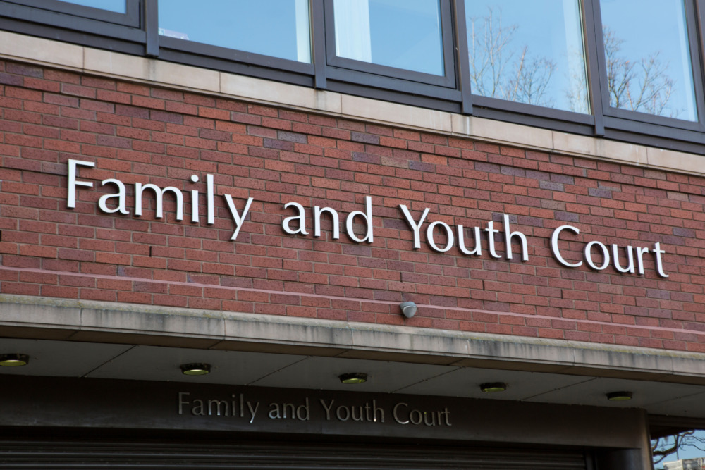 Teen court: Red brick building with close-up of sign in silver letters reading "Family and Youth Court""