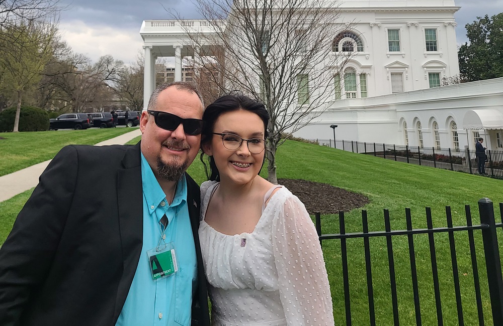 transgender medication law in Alabama blocked by judge: father and daughter stand outside the White House smiling