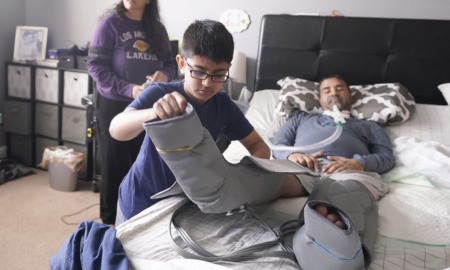 young caregivers offer crucial help: young boy helping bed-ridden father with foot cast
