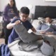 young caregivers offer crucial help: young boy helping bed-ridden father with foot cast