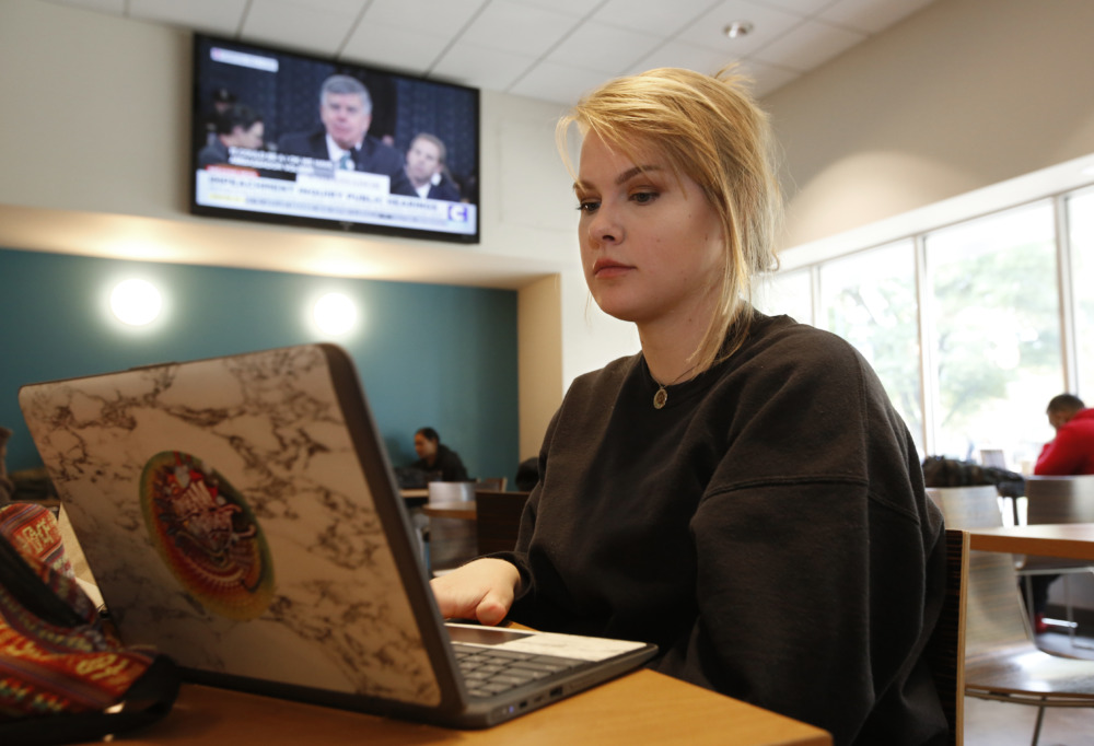 Online SAT: A person with blonde hair sits next to a laptop