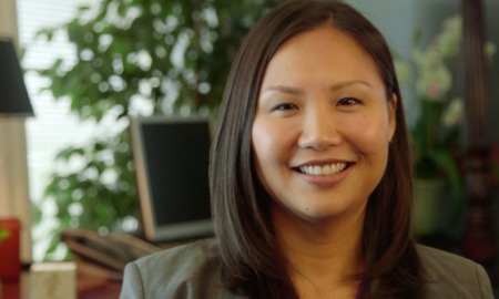 JooYeun Chang new director of child well-being at DDCF: Asian woman with hair to shoulders smiling at camera indoors