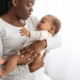 maternity group home for pregnant/parenting youth: young black mother holding crying baby