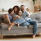 family economic mobility: happy family laughing on couch