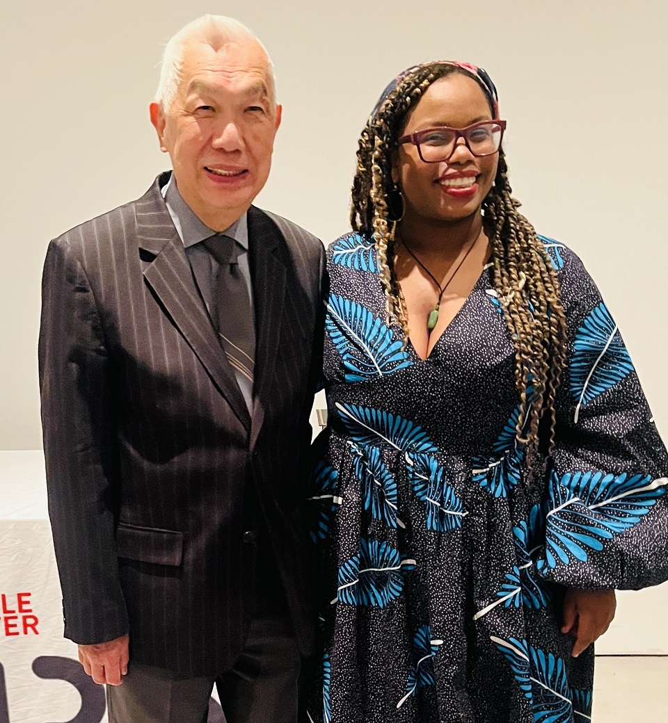 Asian-Black activism rekindled: Older Asian man in poses with young black woman in dress for picture