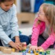 Children's health policy campaign grants: two children play with colorful blocks on the floor