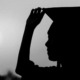 Working at school or nonprofit could erase student loans: silhouette of young woman with graduation cap on