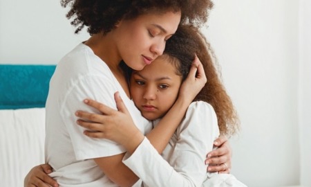 family violence grants: mother comforting her young, sad daughter