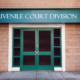 juvenile courtroom division entrance with sign and white-framed green double doors in red brick building