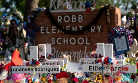 State's plans to make school safer political divides: Robb Elementary School sign with memorial made on and around it