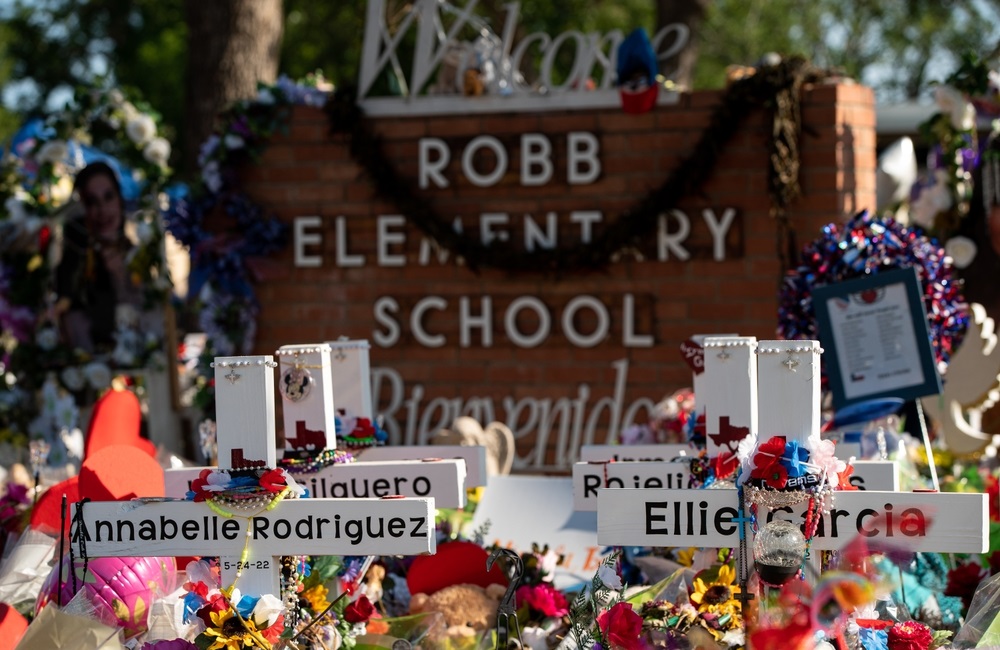 State's plans to make school safer political divides: Robb Elementary School sign with memorial made on and around it