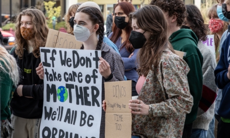 Climate change series: Young people hold protest signs