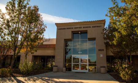 A tan building with the label Corona-Norco Unified School District