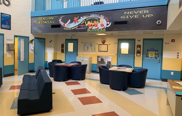 Connecticut turnaround of juvenile system sets standard: common area of juvenile facility with bright colors and motivational banner