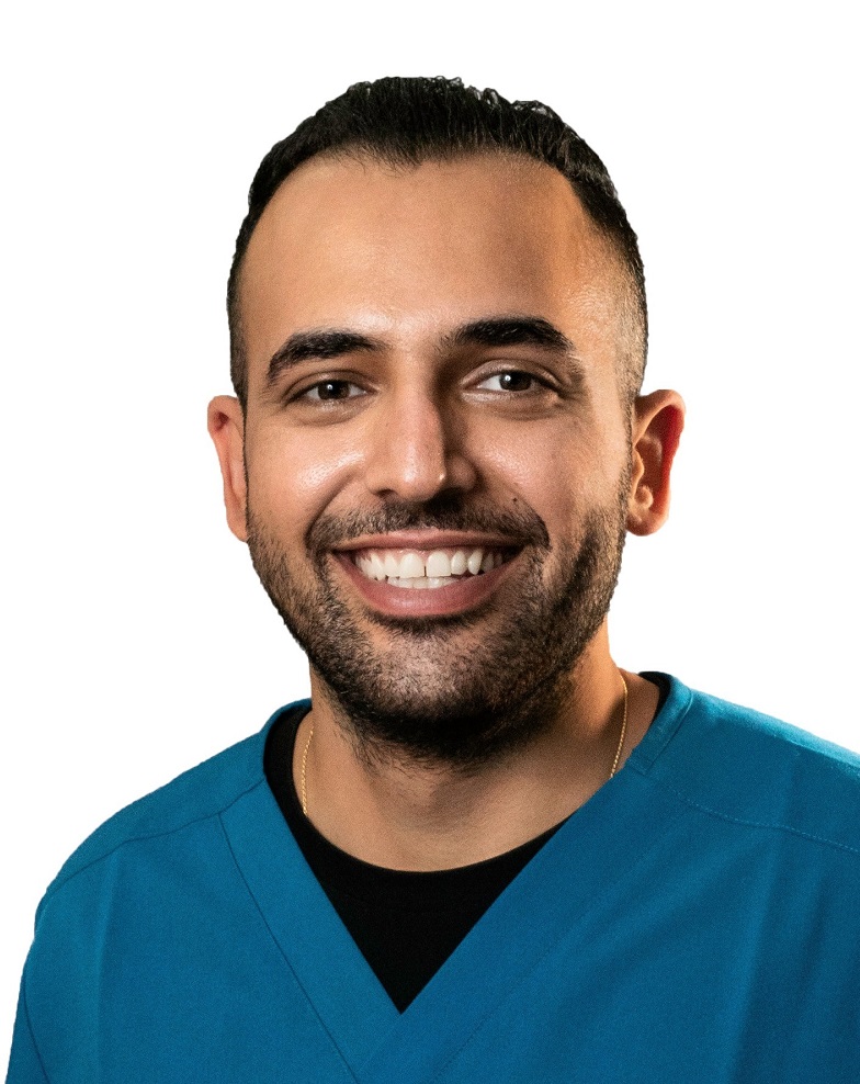 specialized dentistry for children with disabilities: headshot of smiling man medical garb in front of white background
