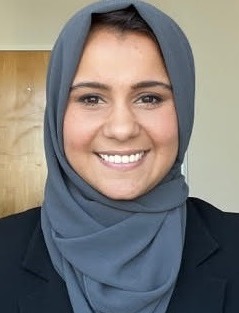 children separated from families due to parental substance use: smiling woman with hijab in office setting