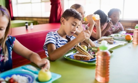 childhood hunger and food access grants; children eating food at table