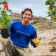 Hawaii Oregon youth, environment, community grants: young man in blue shirt holding plant and smiling