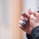 youth drug use survey results: female hands with painted fingernails lighting up a joint