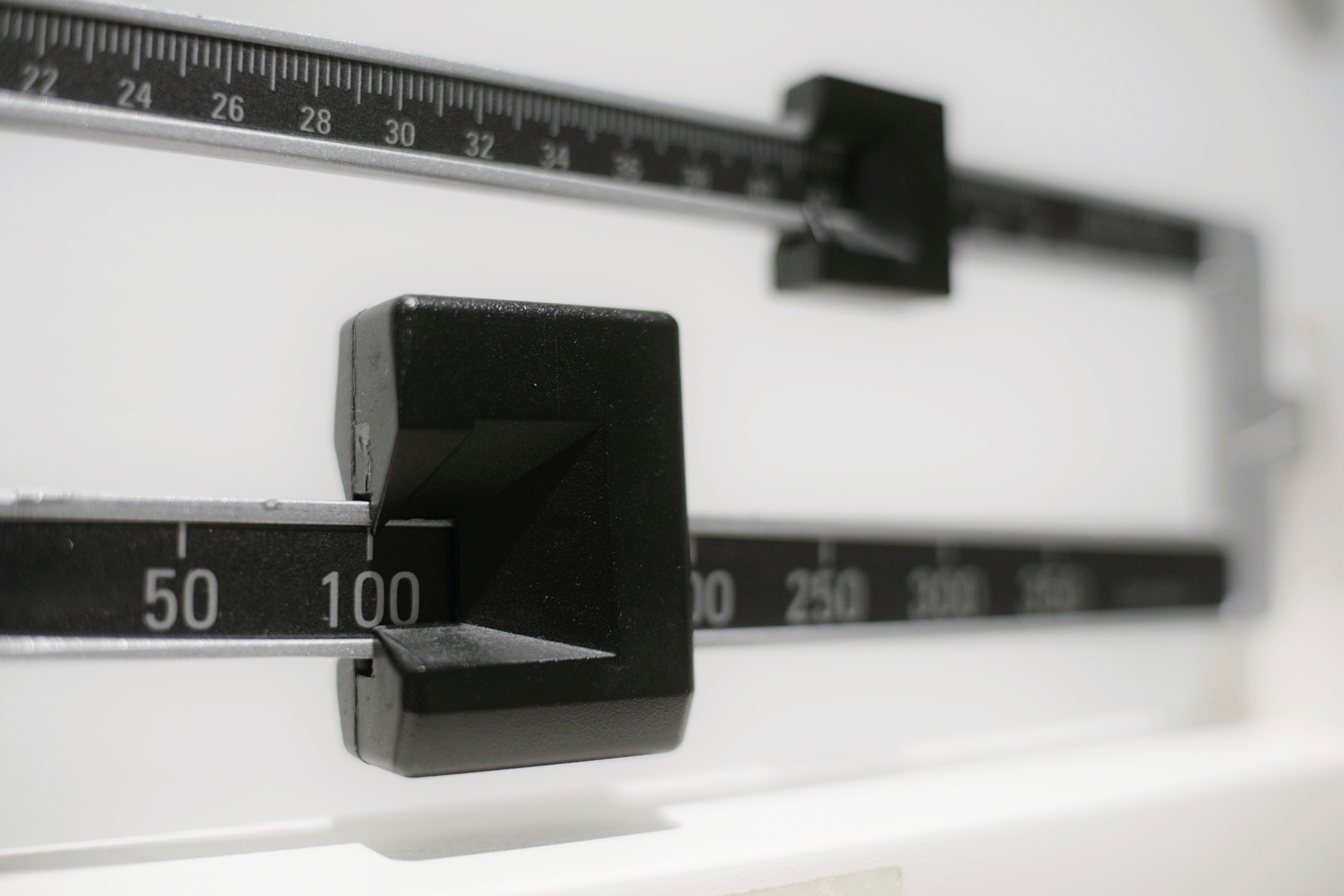 Childhood obesity: closeup of a beam scale