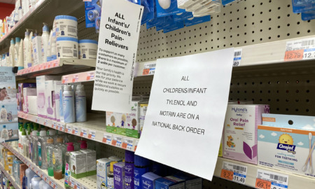 Children's Medicine shortage: Store shelves stocked with childremn's medicine and signs about buying limits and out of stock