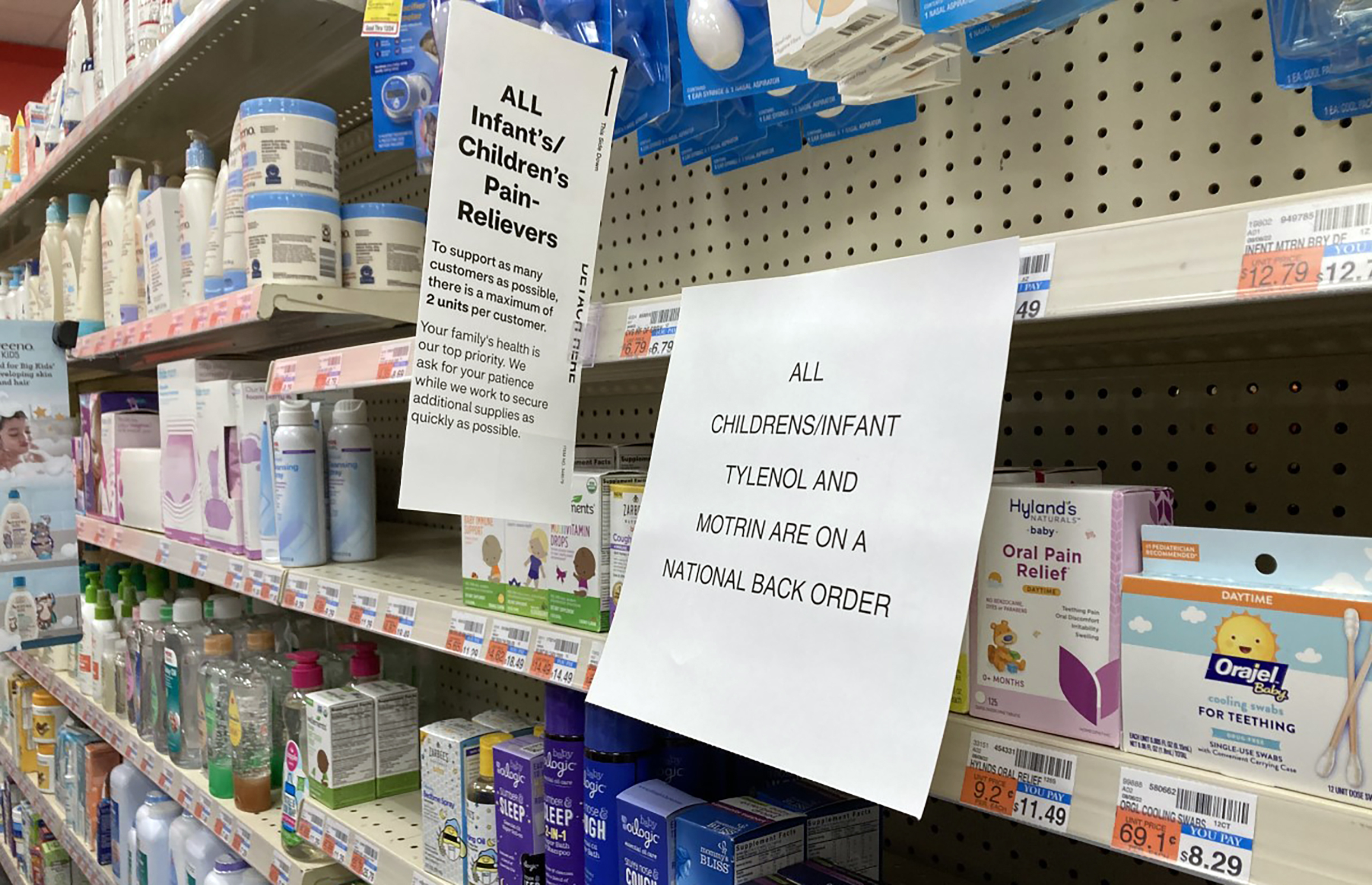 Children's Medicine shortage: Store shelves stocked with childremn's medicine and signs about buying limits and out of stock